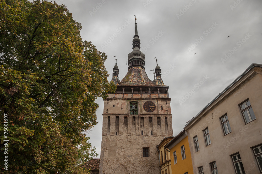 Sighisoara Clock Tower (Turnul cu Ceas) during a cloudy fall afternoon. It is the main entrance of Sighisoara castle, in Romania, birthplace of Vlad Tepes, aka Dracula.