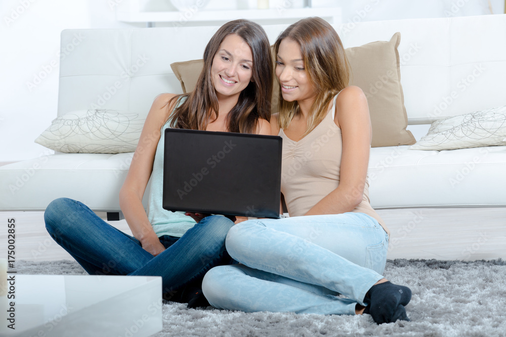 cute young women using laptop on sofa cute young women using laptop on sofa