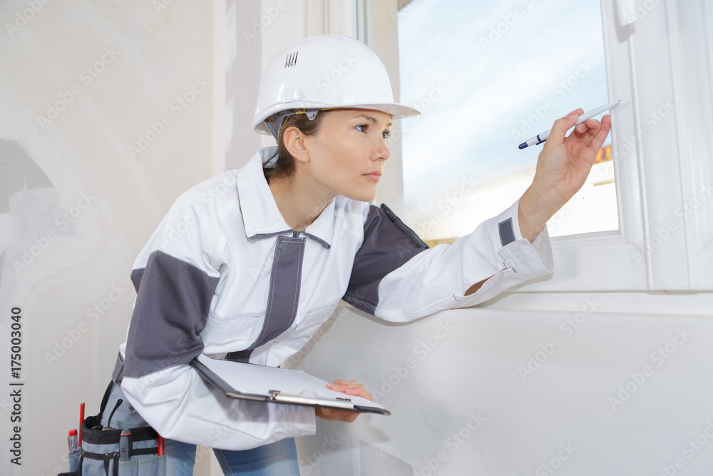 female decorator measuring window frame female decorator measuring window frame