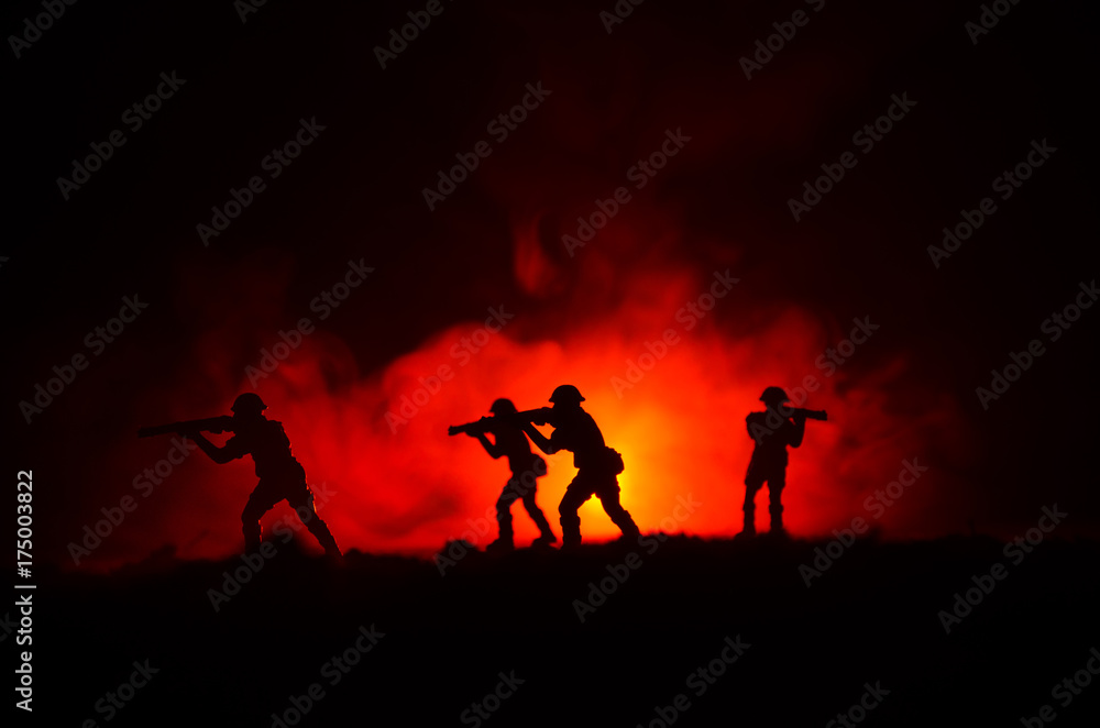 Military silhouettes of soldiers against the backdrop of dark foggy sky. Battle scene with explosion and burning clouds behind fighing soldiers. Toy decoration Military silhouettes of soldiers against the backdrop of dark foggy sky. Battle scene with explosion and burning clouds behind fighing soldiers. Toy decoration