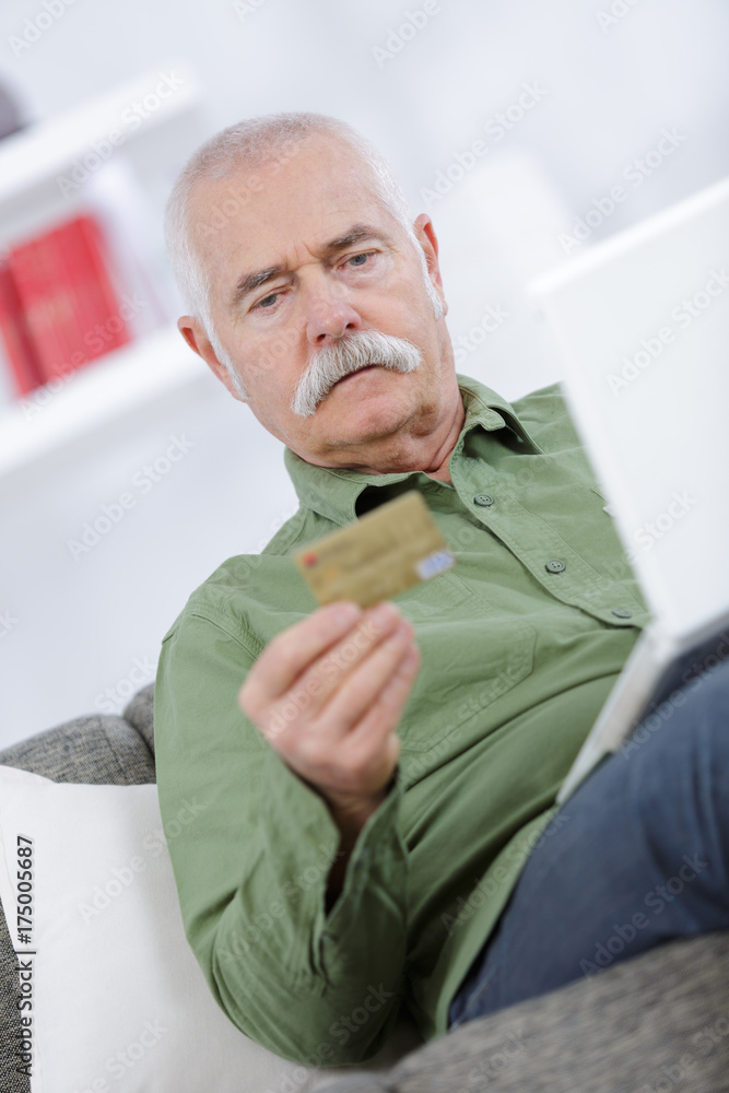 old man purchasing something from the internet old man purchasing something from the internet