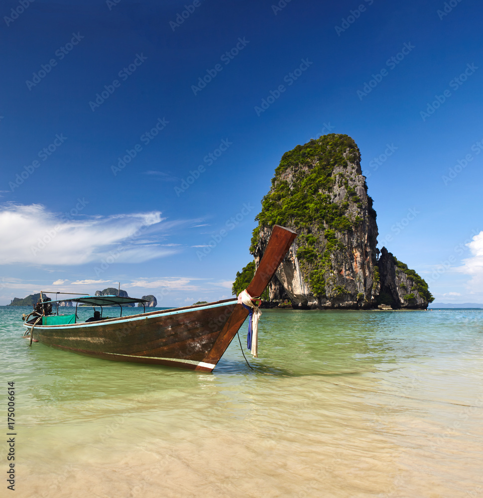 Sea view in Railay beach, Thailand to the assure sea, blue sky, rocks, and boat near cost