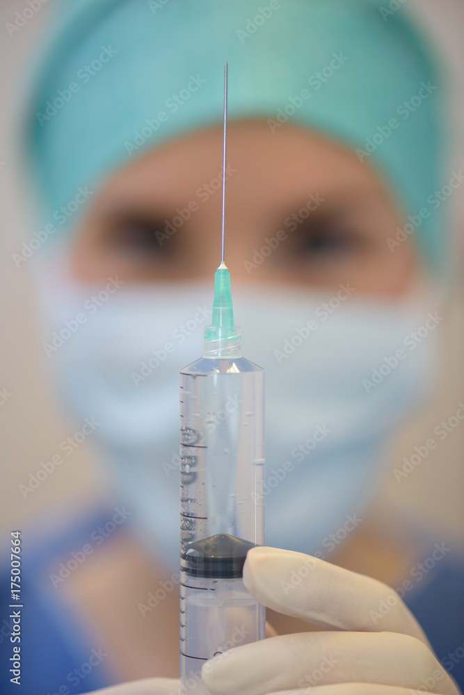 Closeup of syringe held by nurse Closeup of syringe held by nurse