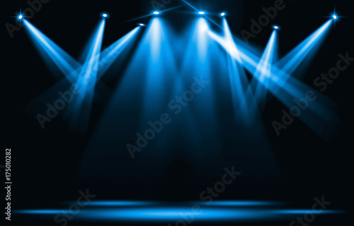 Stage lights. Blue spotlight strike through the darkness. photo