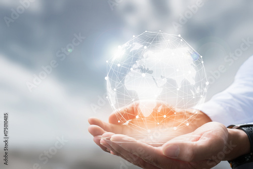 Businessman holding in hand with global connection concept.