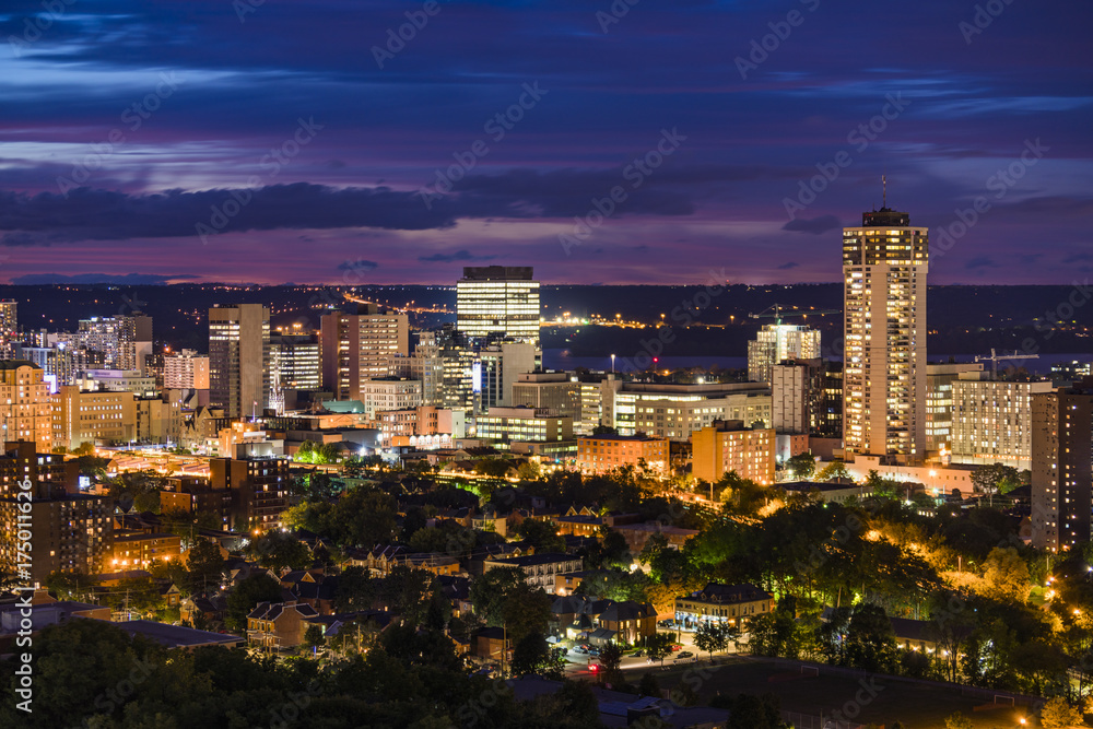 Vibrant city illuminated at dusk with deep blue and crimson sky