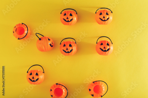 Halloween pumpkin decorations on a yellow-orange background