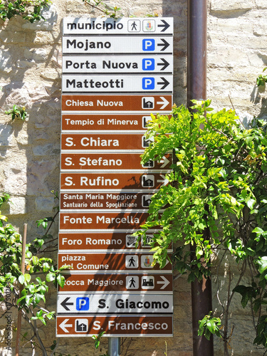 Assisi, Italy. A large number of small-scale signs showing the direction of the various monuments and main services of the city