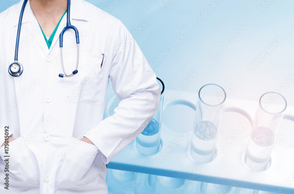 Fototapeta premium smart doctor with a stethoscope and close up chemical liquid in laboratory test tube with light effect background, people, laboratory, science, chemical and medical research concept