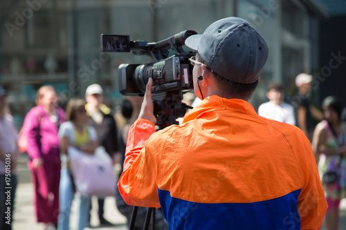 Cameraman filming urban street event recording broadcasting 