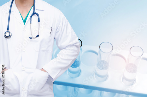 smart doctor with a stethoscope and close up chemical liquid in laboratory test tube with light effect background, people, laboratory, science, chemical and medical research concept