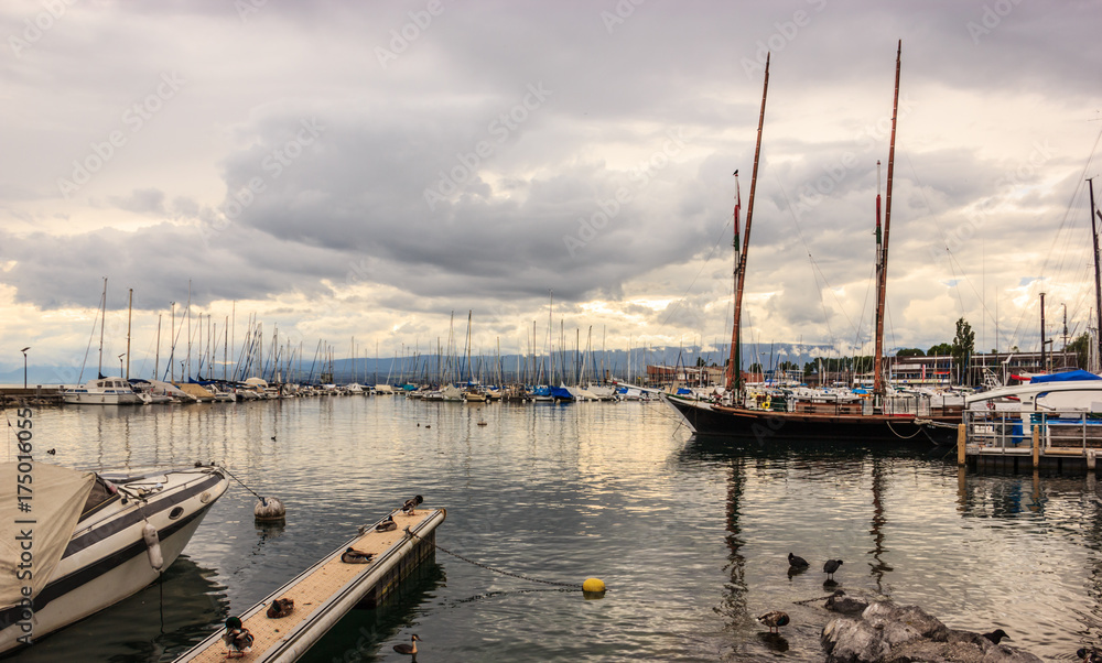 Obraz premium Beautiful Sunset view at Lausanne Marina with yachts on Lake Geneva, Lausanne Ouchy fishing village, Switzerland, Europe.