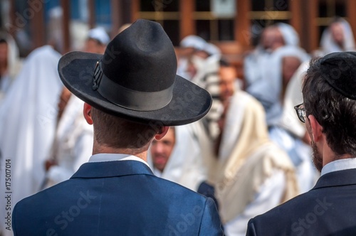 Two adult Hasidim in traditional Jewish headdresses hat and kippah. Prayer of Hasidim.