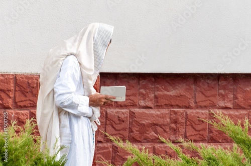 Orthodox hassidic Jew pray in a holiday robe and tallith. photo