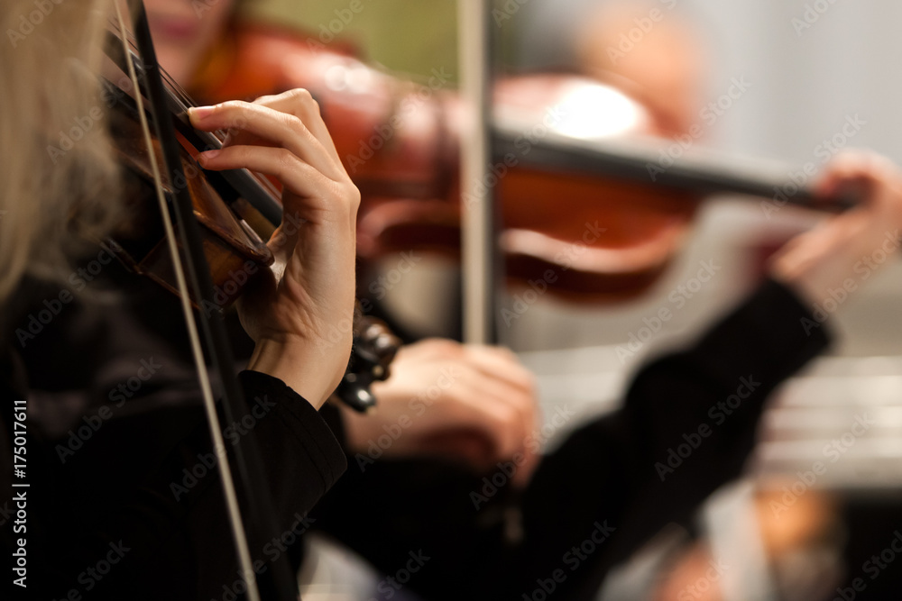 Hands of a woman playing the violin in an orchestra Hands of a woman playing the violin in an orchestra