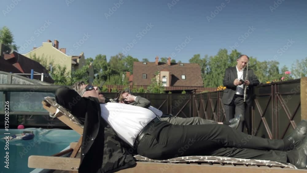 A fat girl falls into a pool and two men in suits try to pull her out. Montage. A fat girl falls into a pool and two men in suits try to pull her out. Montage.