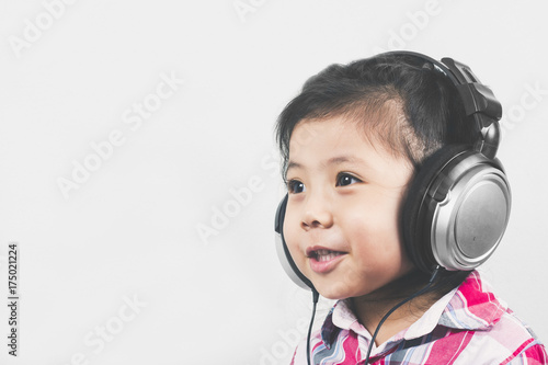 Portrait Asian Girl wear headphones with Long sleeve shirt with red pattern.