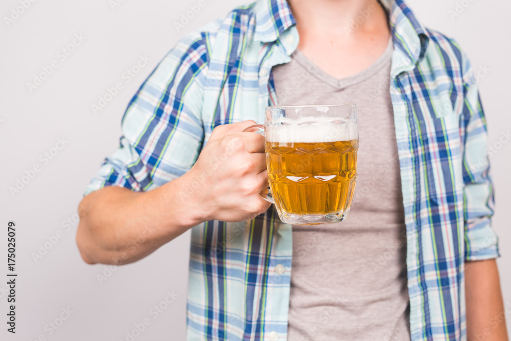 Close up of man holding a mug of beer. Close up of man holding a mug of beer.