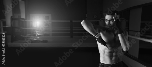 Afro american male boxer. Young man boxing workout in a fitness club. Muscular strong man on background boxing gym. © A Stock Studio