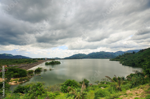Fototapeta Naklejka Na Ścianę i Meble -  Large Lake among Hills under Grey Clouds in Vietnam