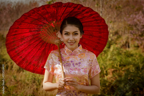 Canvas Print Beautiful woman wearing china traditional dress gold red umbrella and smiling happiness