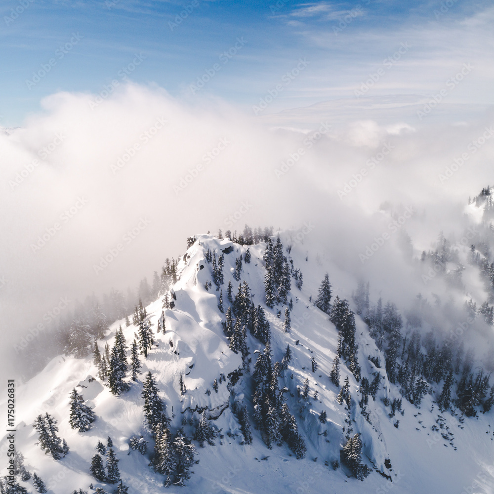 Stylized Aerial Vew of Snowy Mountain Top and Hazy Fog Clouds Stylized Aerial Vew of Snowy Mountain Top and Hazy Fog Clouds