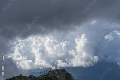 the cable car to the top of the mountains against the fluffy white clouds © vvicca