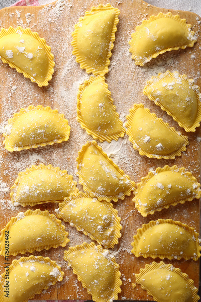 Fresh ravioli on wood background