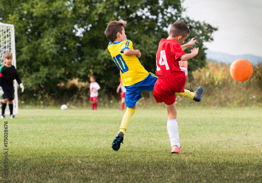 Kids soccer football - children players match on soccer field