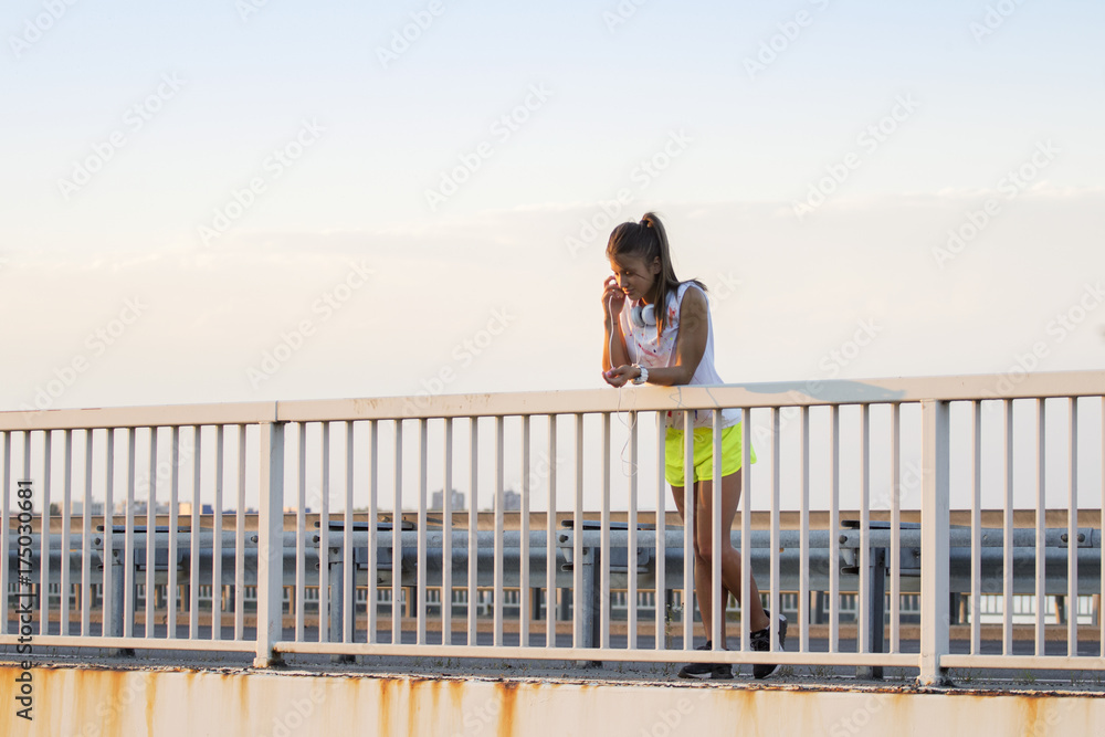 Young girl using mobile phone after jogging