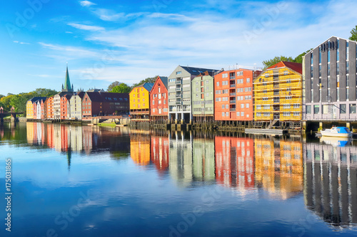 River Nidelva and historical timber buildings along the river in the norwegian city trondheim 