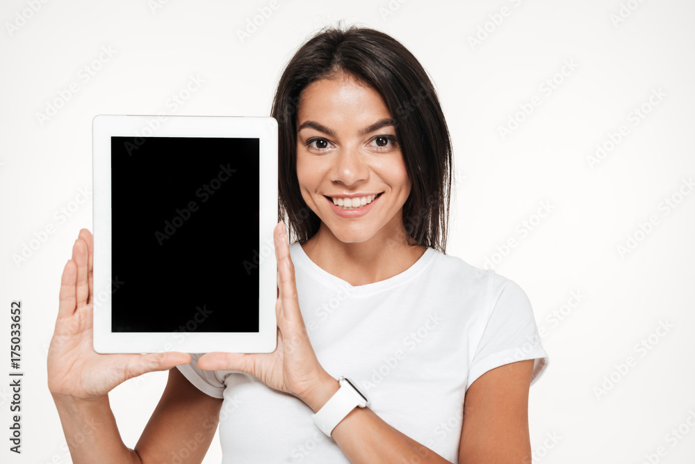 Portrait of a smiling brunette woman showing blank screen tablet Portrait of a smiling brunette woman showing blank screen tablet