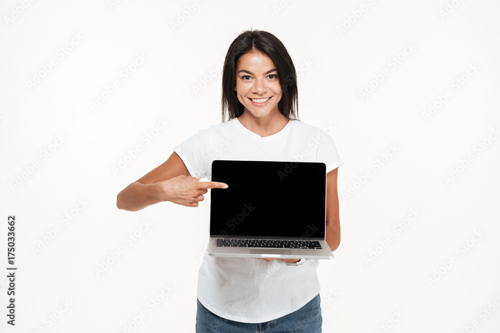 Portrait of a joyful young woman holding blank screen laptop Portrait of a joyful young woman holding blank screen laptop
