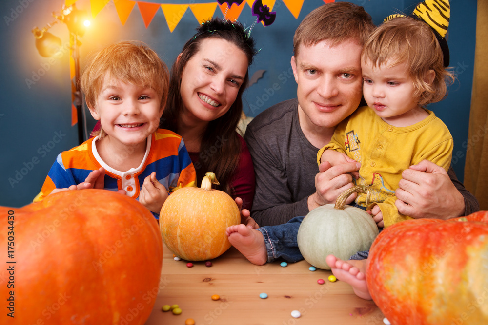 Fototapeta premium happy family mother father and two children in costumes on a celebration of Halloween