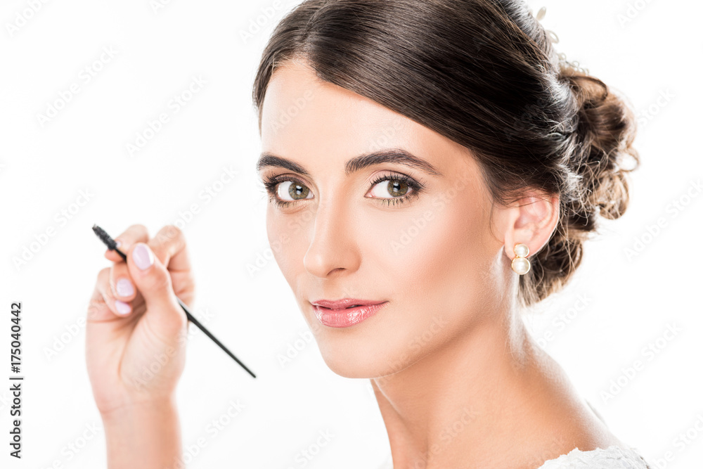 woman with eyebrows brush in hand