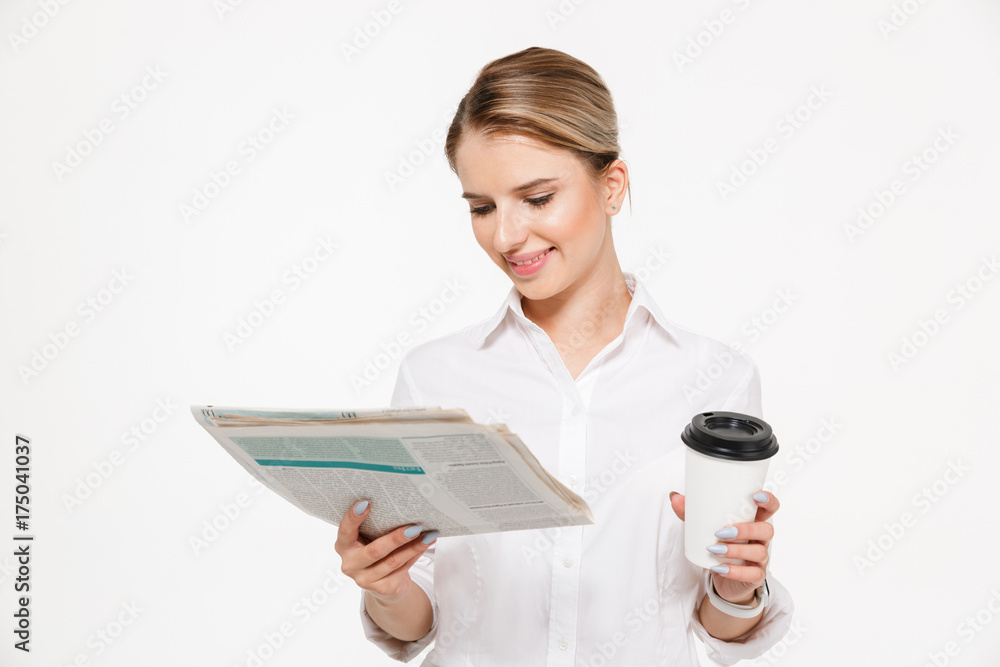 Cheerful blonde business woman reading newspaper Cheerful blonde business woman reading newspaper