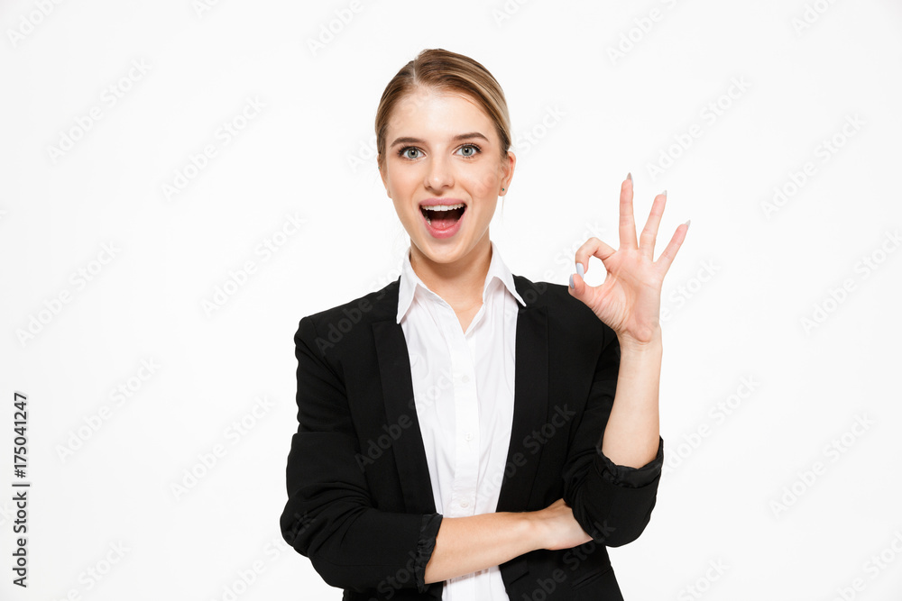 Happy blonde business woman showing ok sign Happy blonde business woman showing ok sign