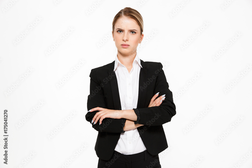 Displeased blonde business woman looking at camera with crossed arms Displeased blonde business woman looking at camera with crossed arms