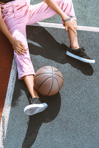 basketball near female leg