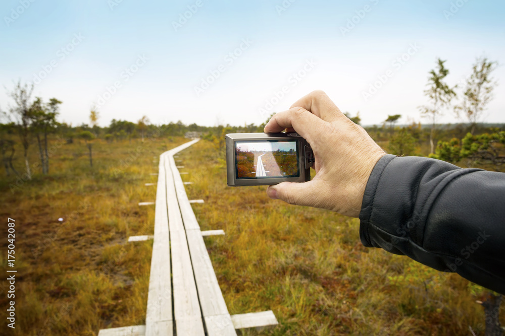 Person shoots a landscape with the camera