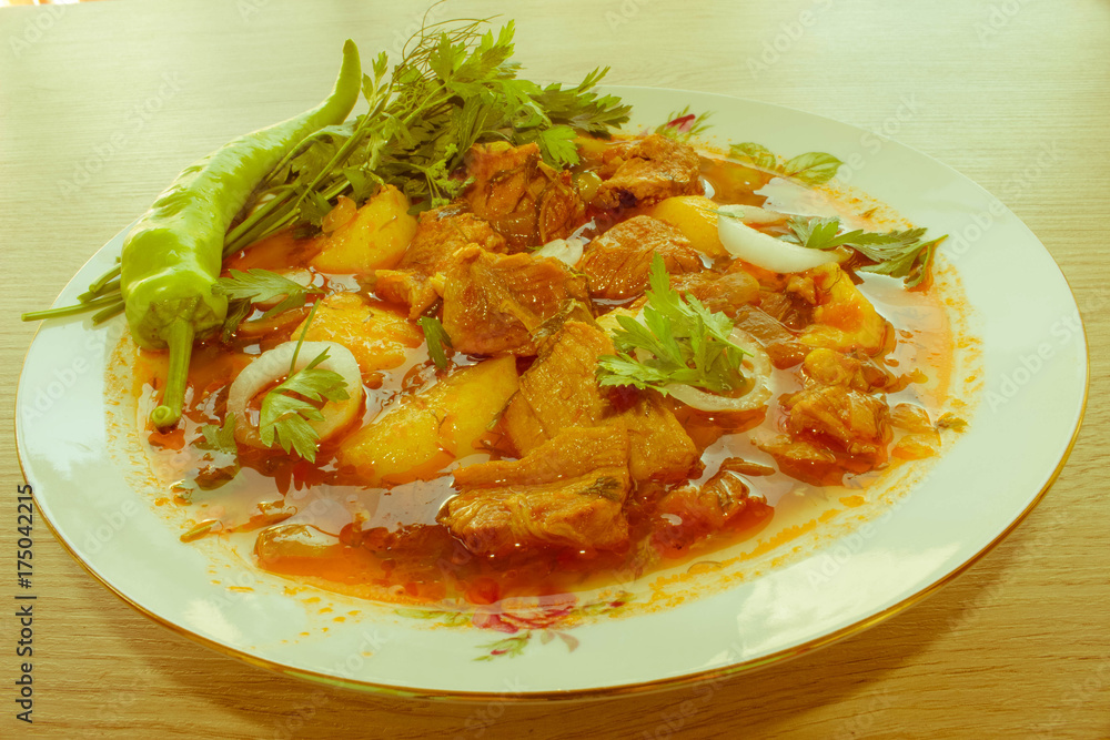 A bowl of delicious beef and tomato, potato A bowl of delicious beef and tomato, potato