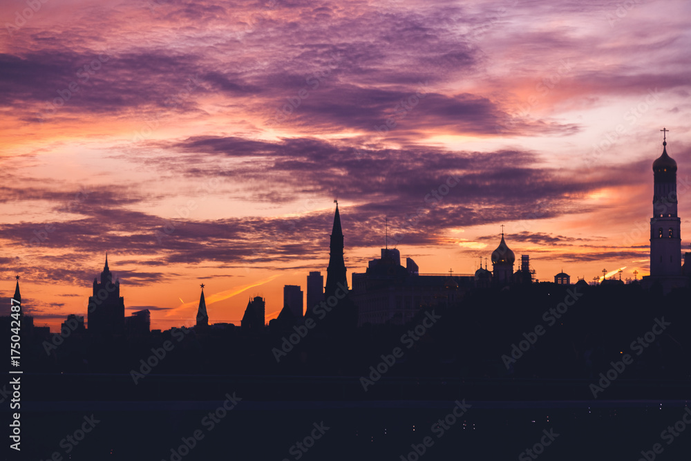 Dark silhouette of buildings against the background of a bright sunset sky, Moscow, Russia, beautiful urban background