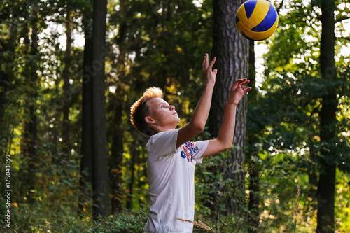 teenager playing boll on vacation in the forest