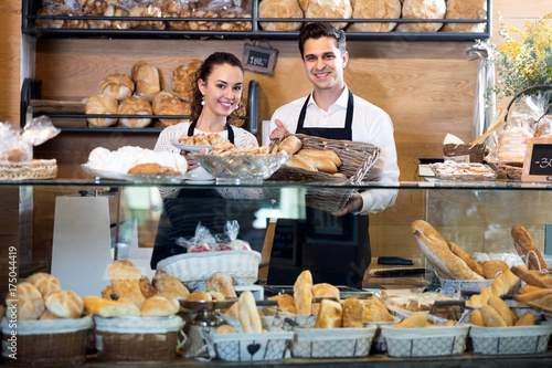 Bakery staff offering bread and different pastry