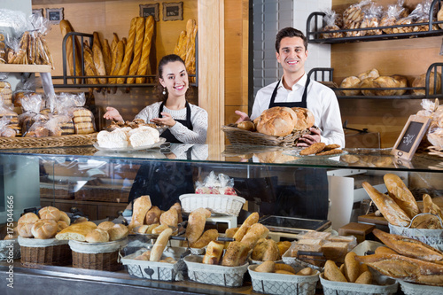 Portrait of charming pleasant couple at bakery display