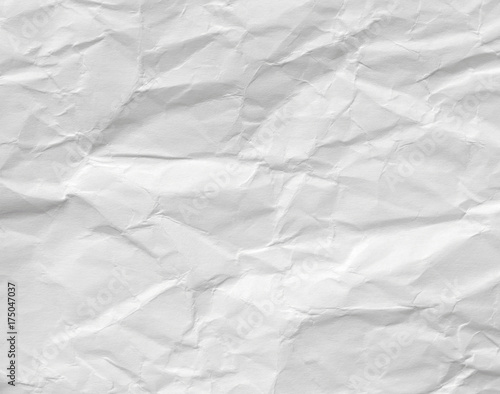 Background of white crumpled paper. Texture of an old surface with kinks and divorces.