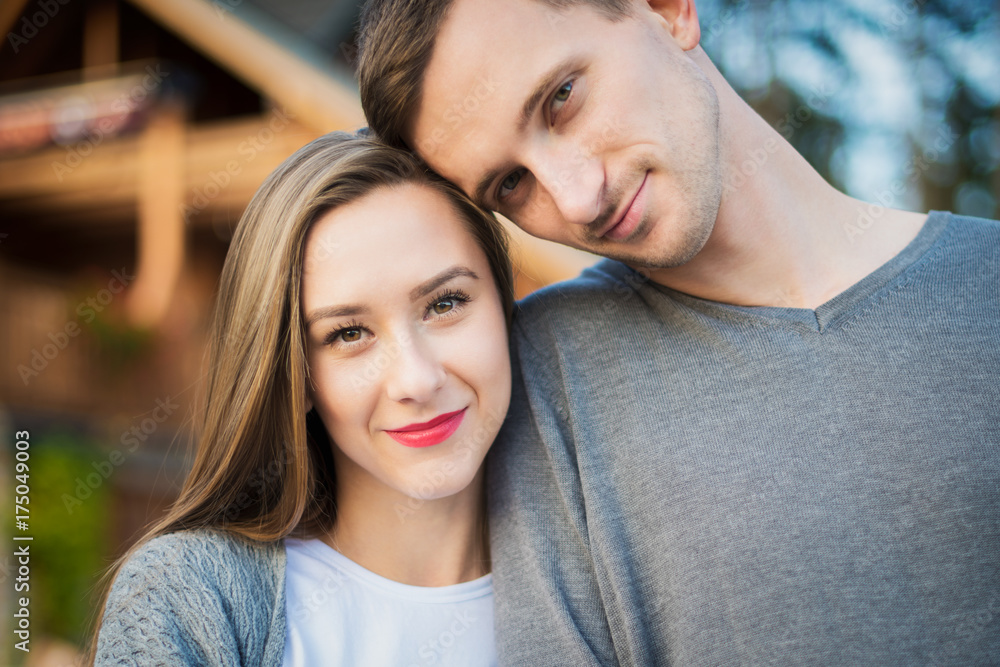 Happy young couple in love hugging. Park outdoors date. Loving couple looking at camera portrait.