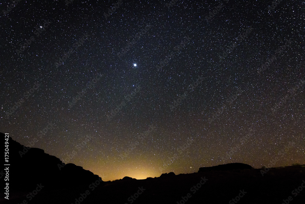 Wadi Rum, view of the stars shining across the sky, full moon. Wadi Rum, view of the stars shining across the sky, full moon.