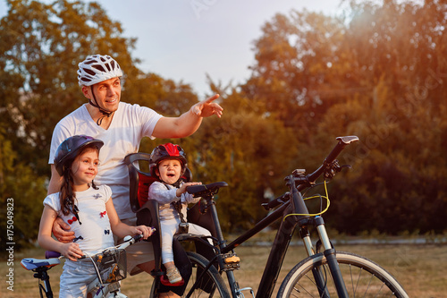 Cheerful family biking in park