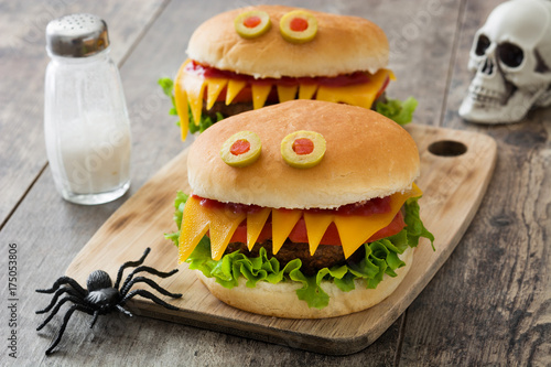 Halloween burger monsters on wooden table
